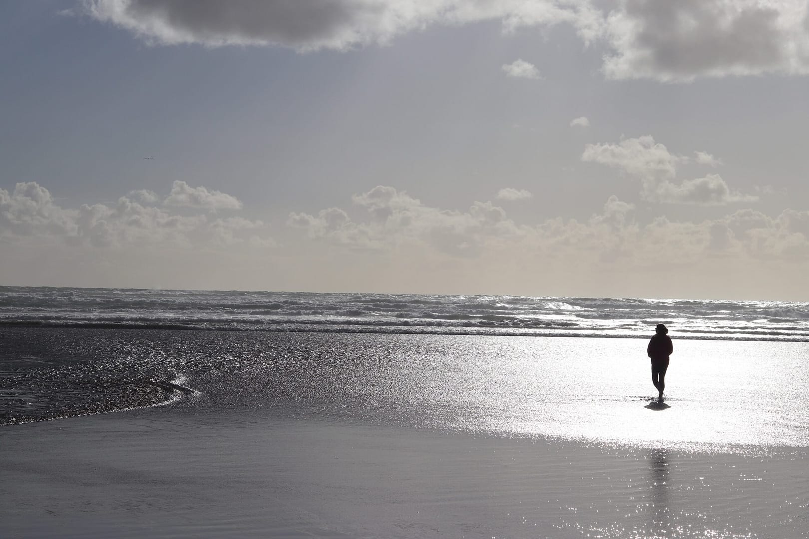 Megan standing on beach of Pacific ocean